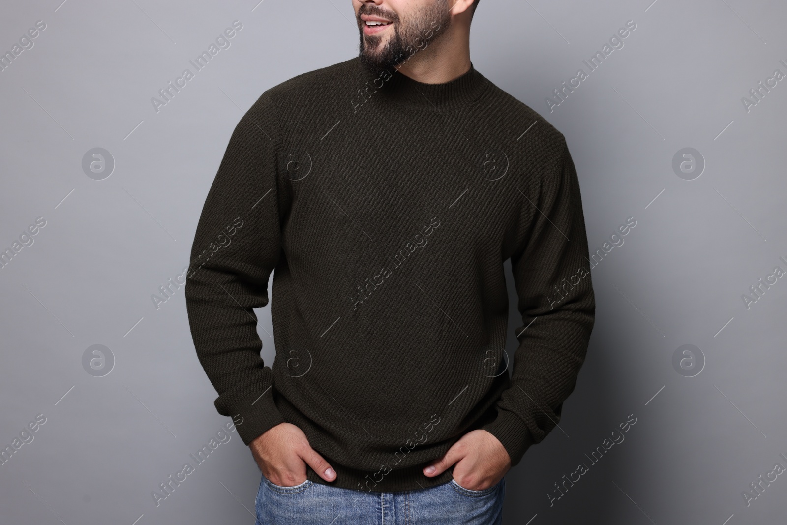 Photo of Man in stylish sweater on grey background, closeup