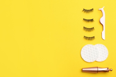 Photo of Flat lay composition with magnetic eyelashes and accessories on yellow background. Space for text