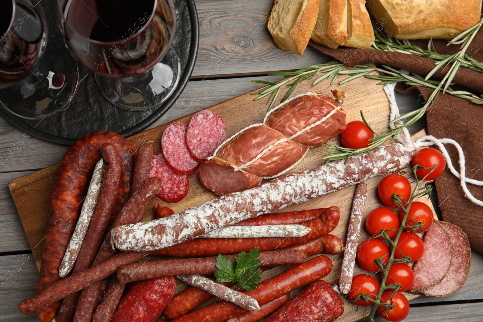 Photo of Different tasty sausages on wooden table, flat lay