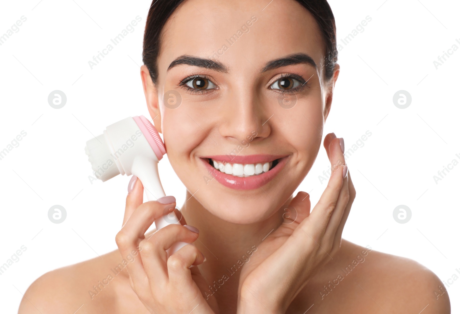 Photo of Young woman using facial cleansing brush on white background. Washing accessory