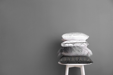 Photo of Chair with many different pillows and space for text on color background