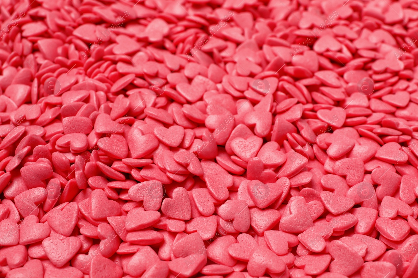 Photo of Sweet candy hearts as background, closeup view