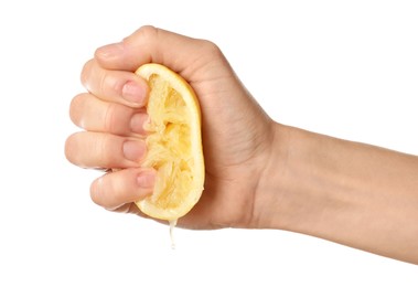 Photo of Woman squeezing lemon half on white background, closeup