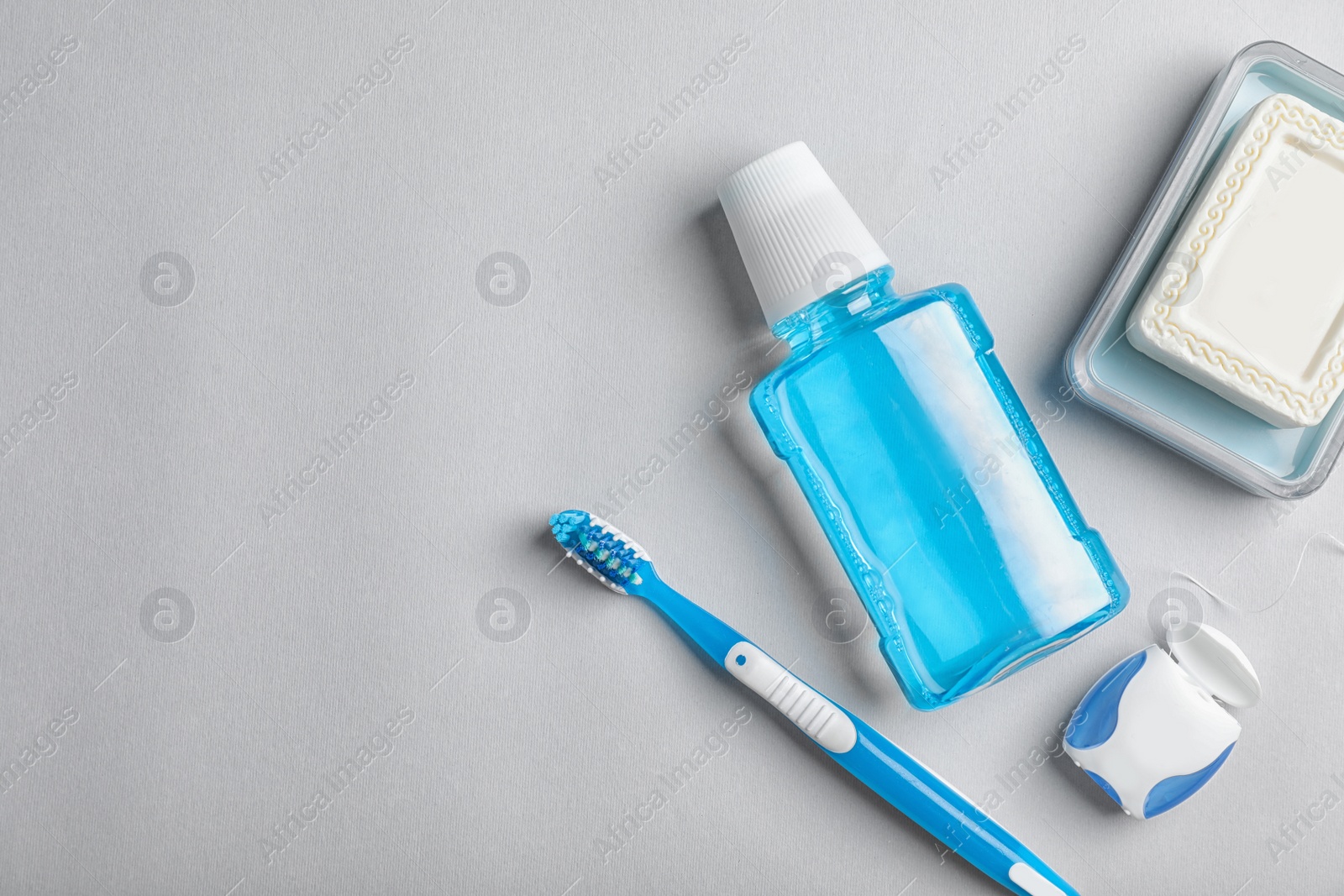 Photo of Flat lay composition with oral care products and space for text on light background. Teeth hygiene