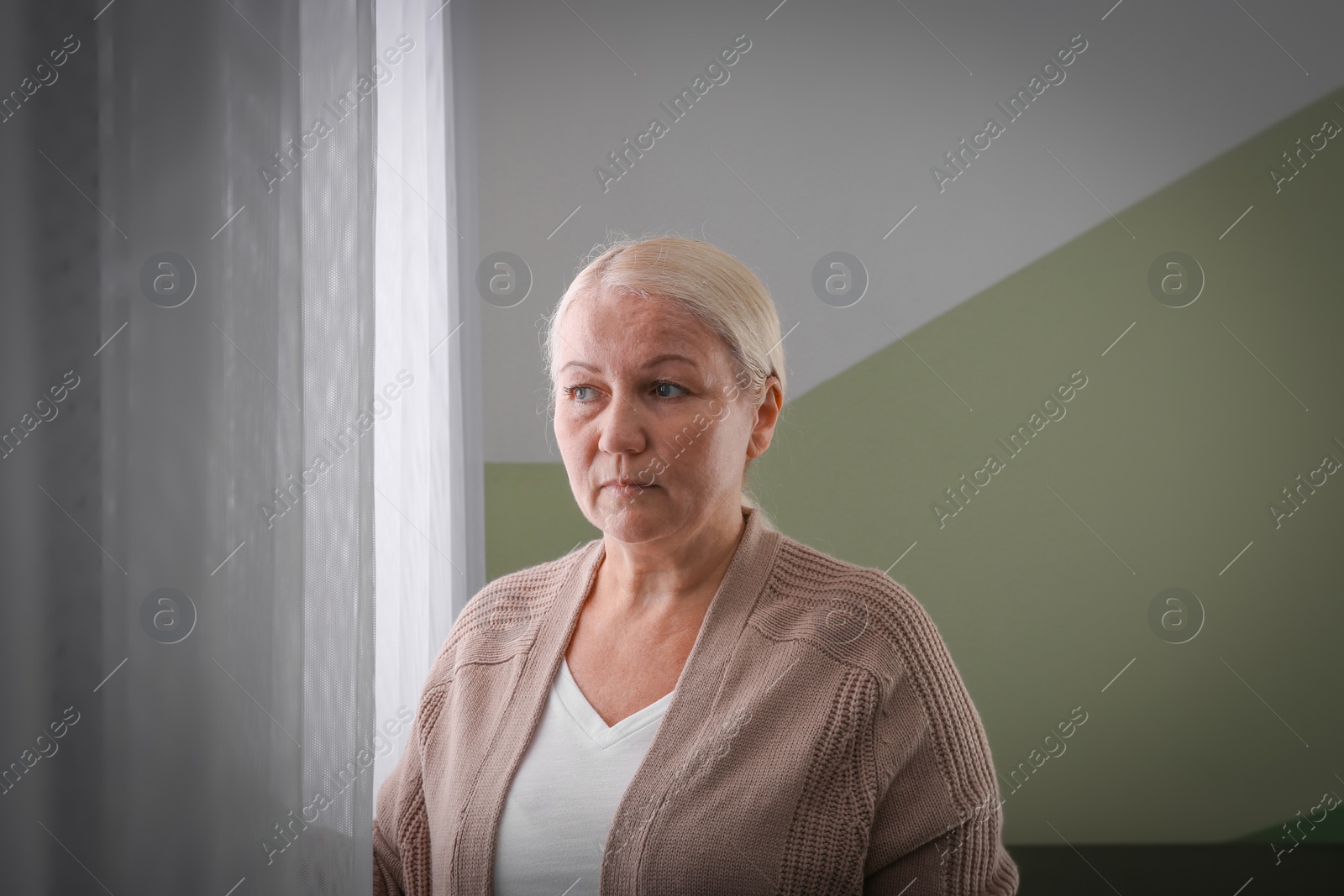 Photo of Mature woman suffering from depression at home