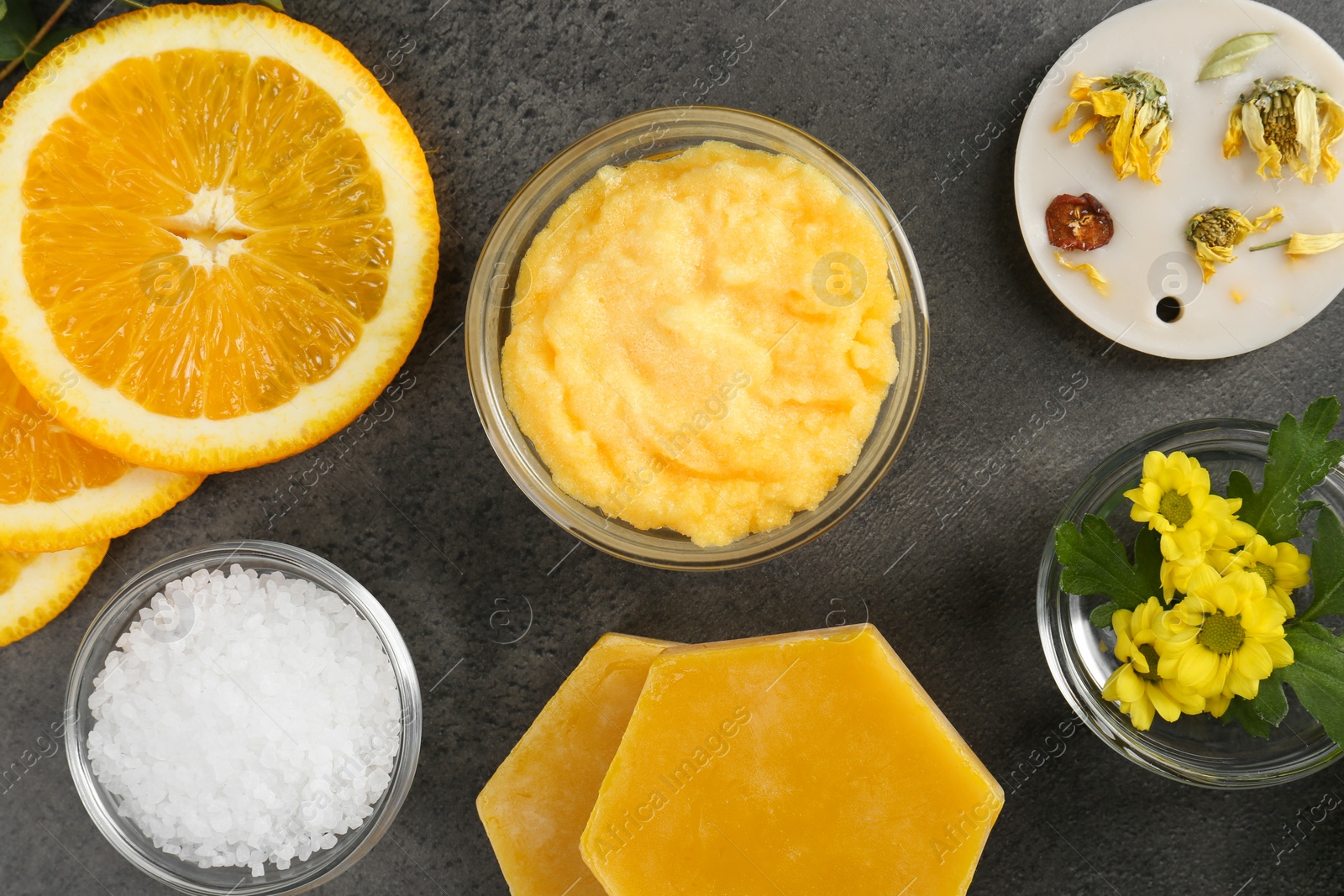 Photo of Homemade cosmetic products and fresh ingredients on black table, flat lay