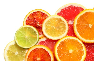 Slices of fresh citrus fruits on white background, top view