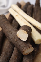 Raw salsify roots on table, closeup view