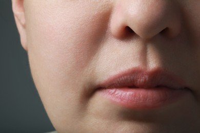 Closeup view of woman with healthy skin on grey background