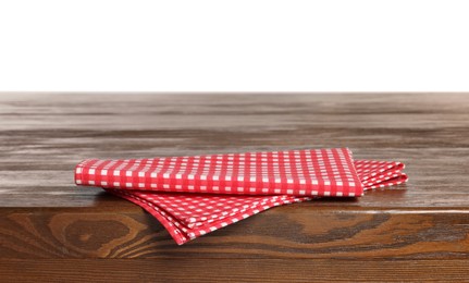 Photo of Checkered tablecloth on wooden table against white background