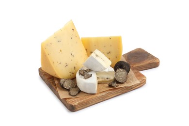 Photo of Wooden board with delicious cheeses and fresh black truffles isolated on white