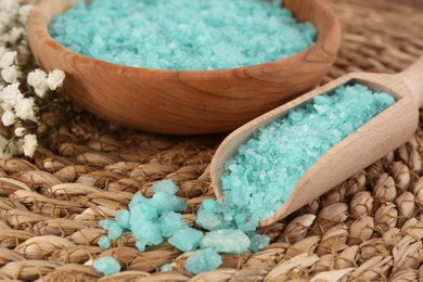 Bowl and spoon with sea salt on wicker mat, closeup