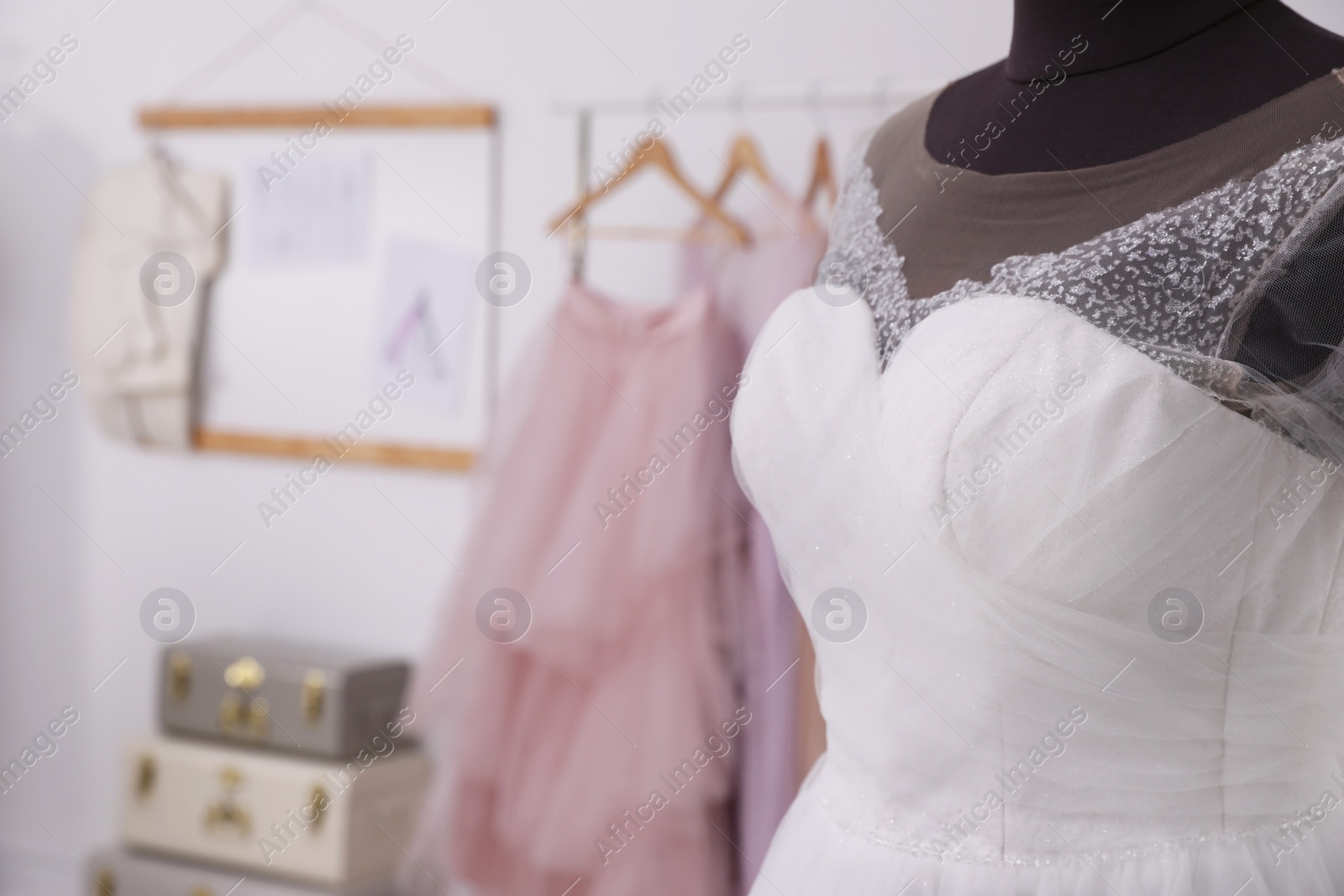 Photo of Mannequin with beautiful wedding dress in atelier. Space for text