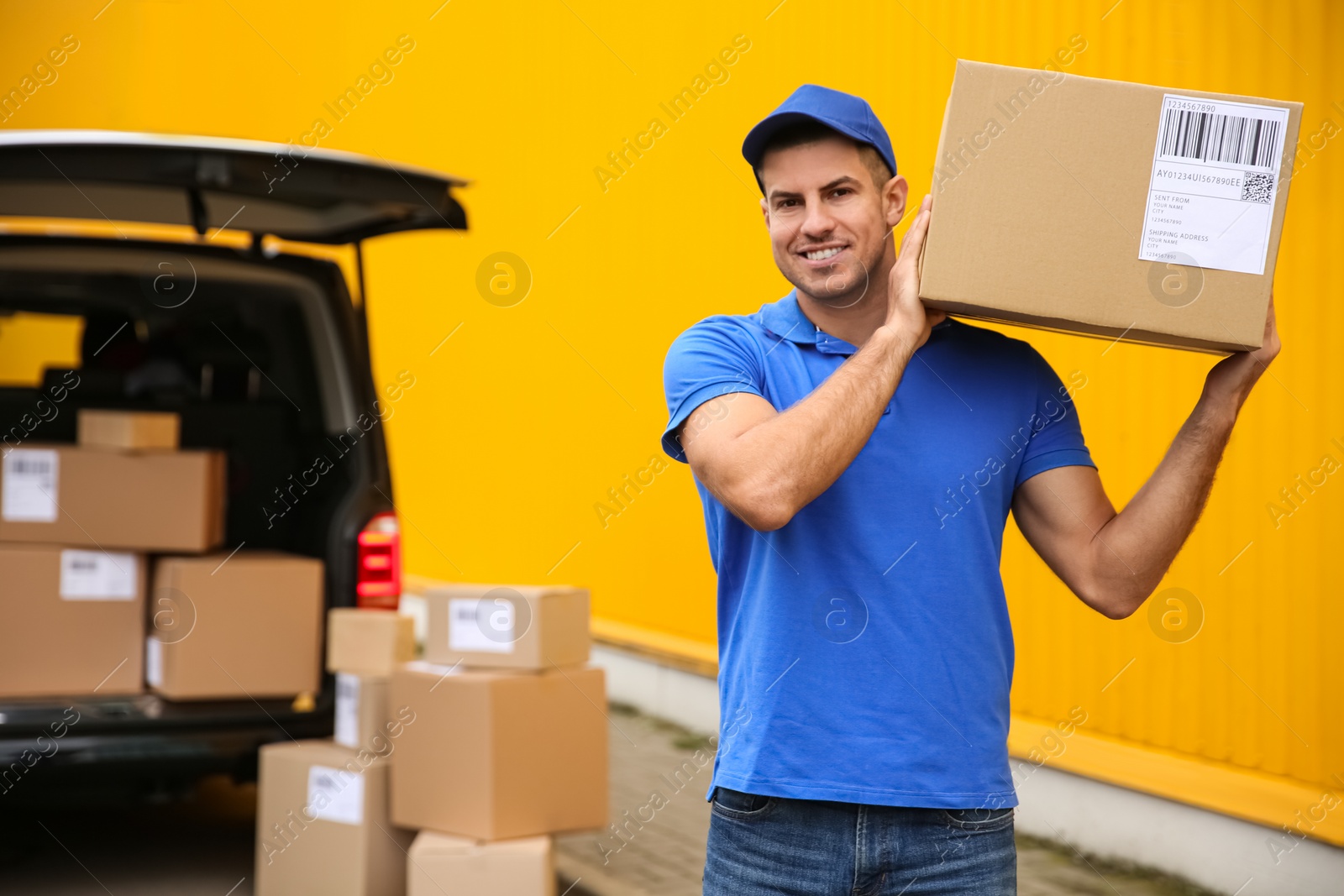 Photo of Courier with parcel near delivery van outdoors. Space for text