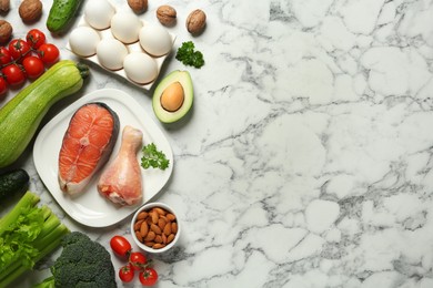 Photo of Flat lay composition with different fresh products on white marble table, space for text. Keto diet