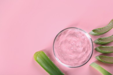 Aloe vera leaves and cosmetic gel on pink background, top view. Space for text