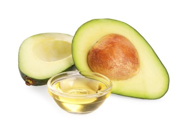Photo of Cooking oil and fresh avocado halves isolated on white
