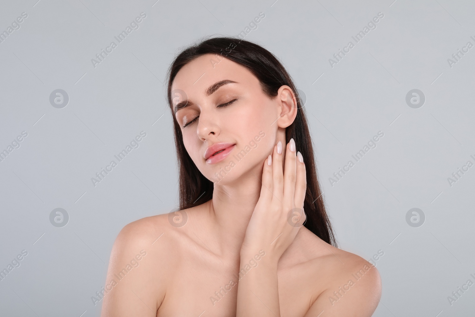 Photo of Portrait of beautiful young woman on light grey background