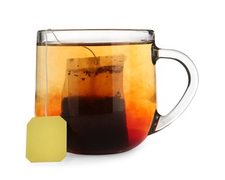 Photo of Tea bag in glass cup of hot water isolated on white