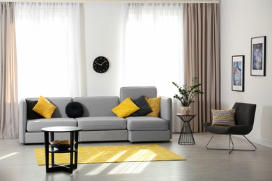 Photo of Stylish living room interior with comfortable sofa. Space for text