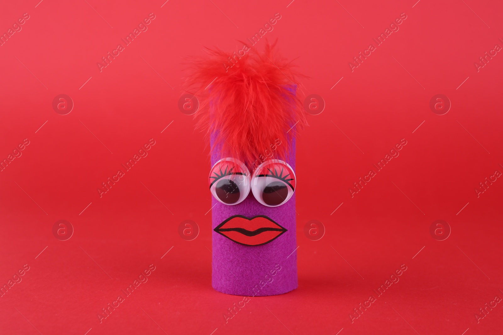 Photo of Purple monster on red background. Handmade Halloween decoration