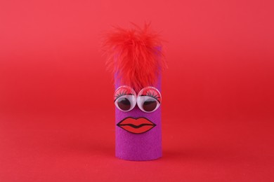 Photo of Purple monster on red background. Handmade Halloween decoration