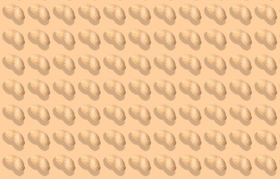 Image of Pattern of unpeeled peanuts on beige background