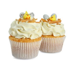 Photo of Tasty Easter cupcakes with vanilla cream isolated on white