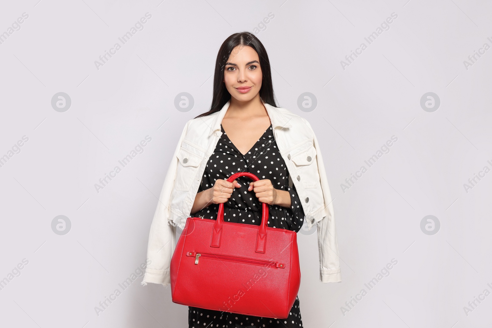 Photo of Young woman with stylish bag on white background,