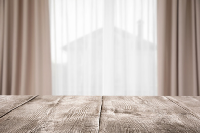 Image of Empty wooden table in room. Space for design