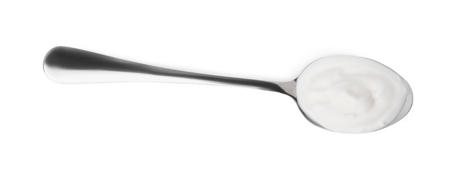 Delicious natural yogurt in spoon isolated on white, top view