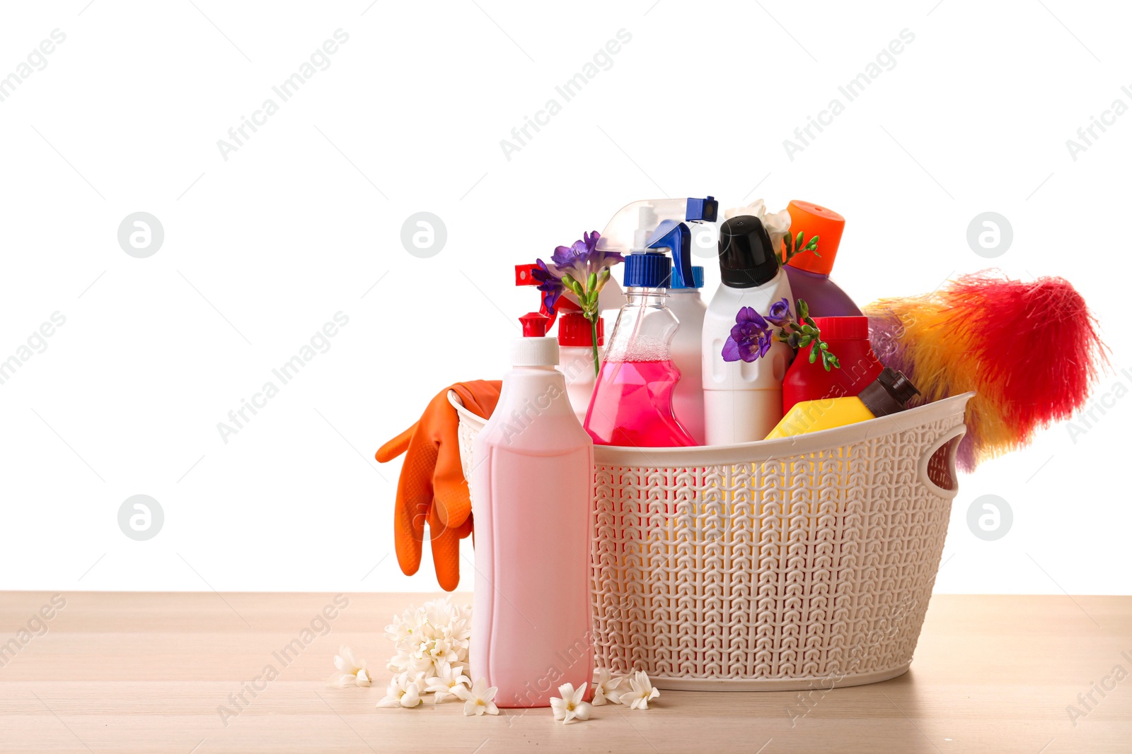 Photo of Spring flowers and cleaning supplies on wooden table