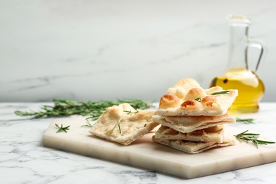 Delicious focaccia bread on white marble table