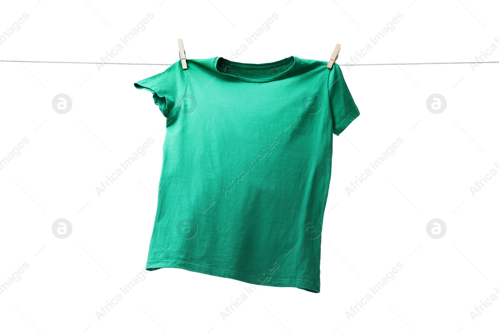 Photo of One green t-shirt drying on washing line isolated on white