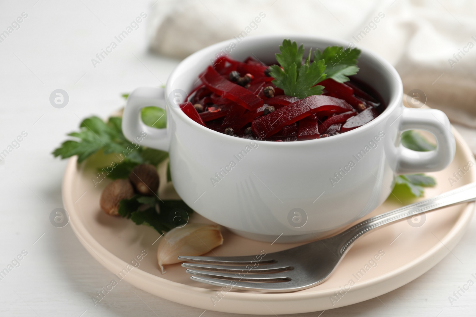 Photo of Delicious pickled beets on white wooden table