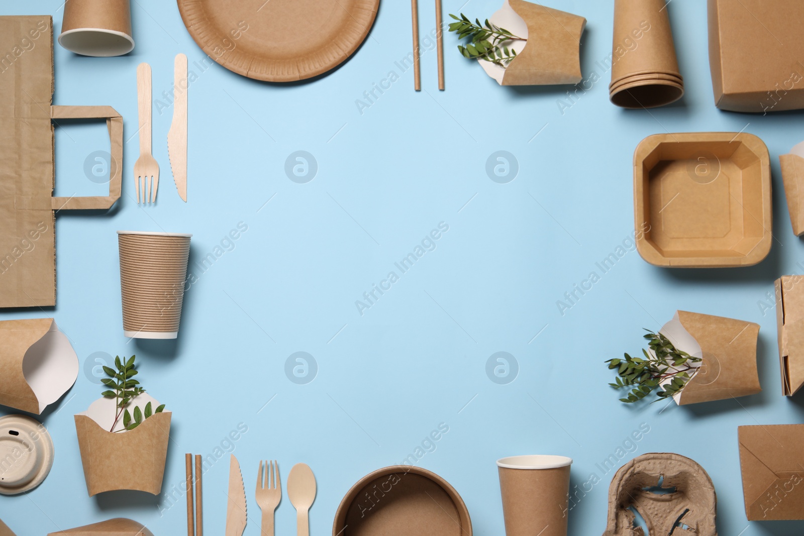 Photo of Frame of eco friendly food packagings and twigs on light blue background, flat lay. Space for text