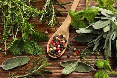 Photo of Different fresh herbs and spices on wooden table, flat lay