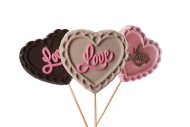 Photo of Heart shaped lollipops made of chocolate on white background