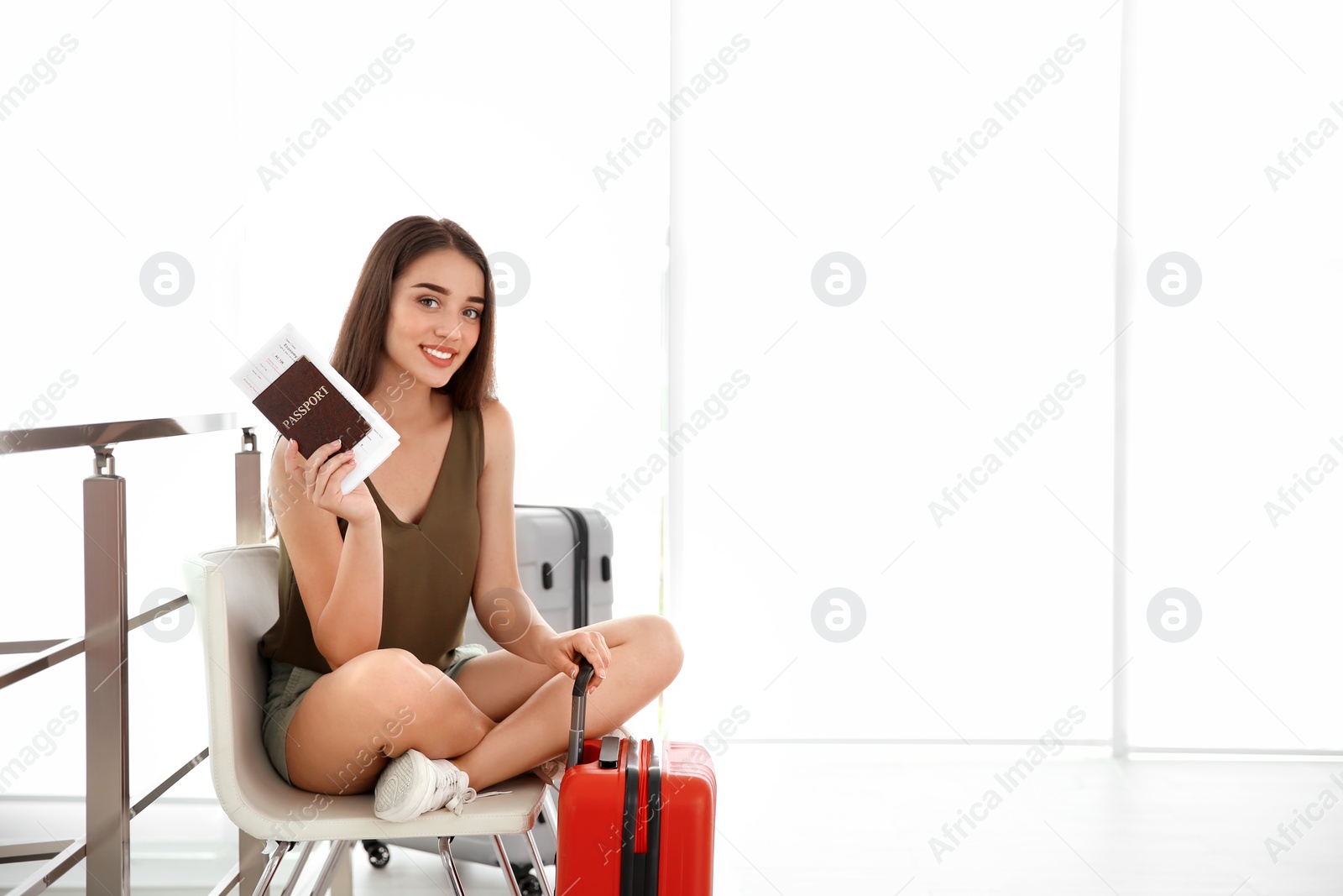 Photo of Young woman with suitcase in airport