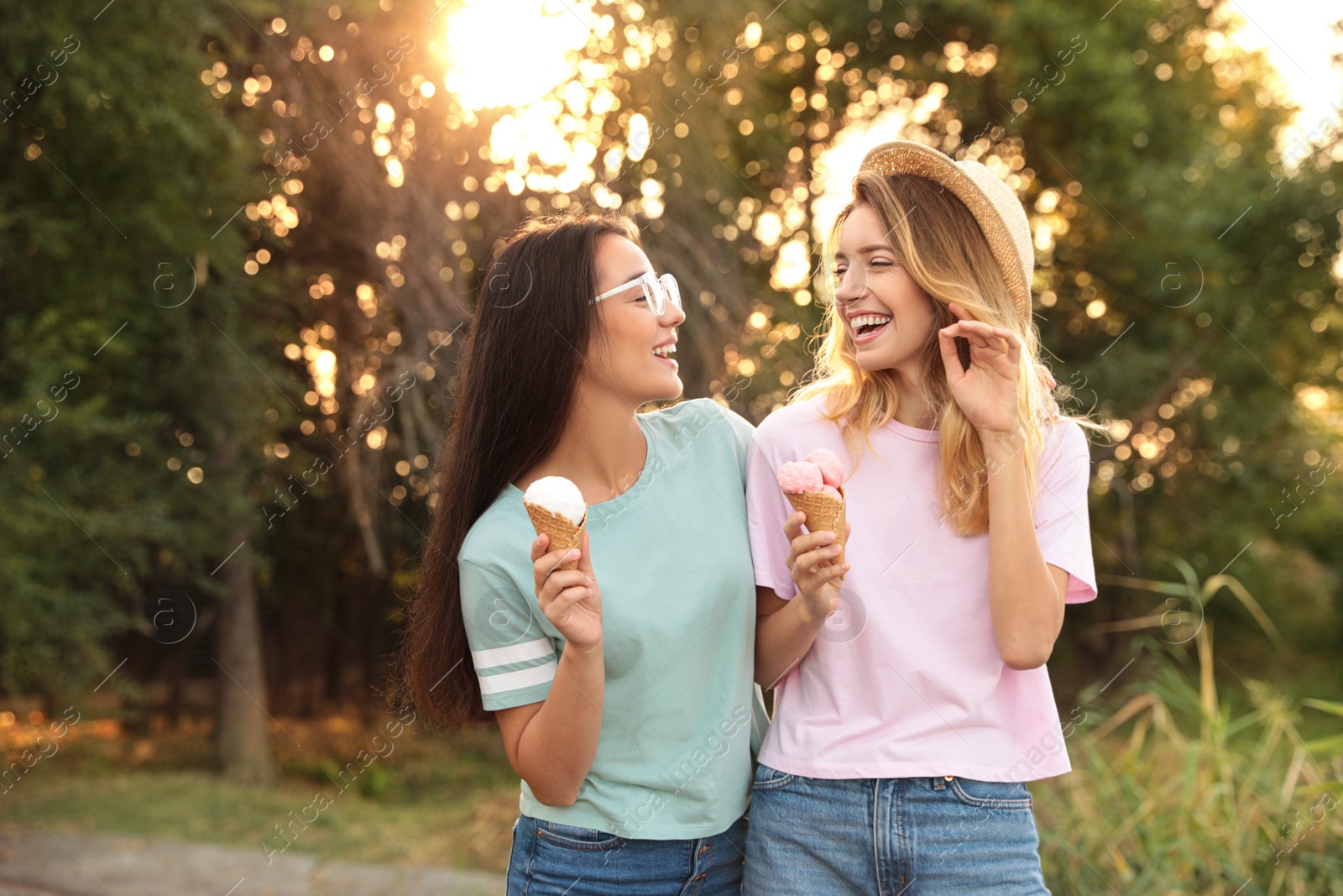 Photo of Young women with ice cream spending time together outdoors