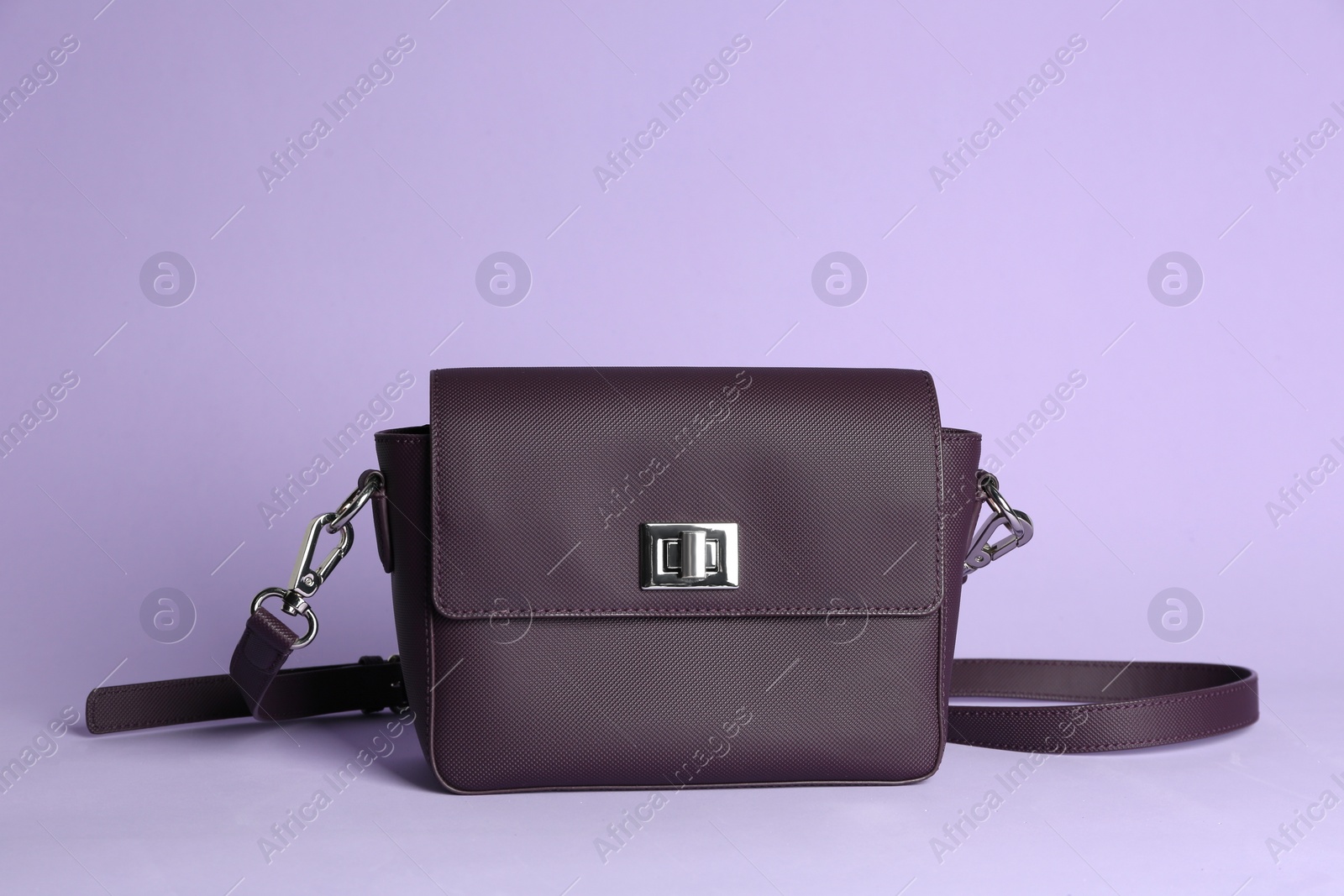 Photo of Stylish elegant woman's bag on lilac background