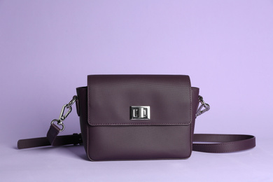 Stylish elegant woman's bag on lilac background