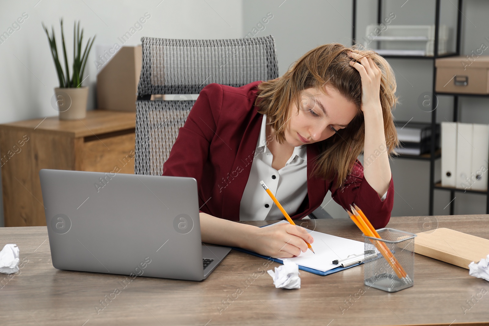 Photo of Sad businesswoman working at wooden table in office