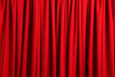 Photo of Closed elegant red front curtains as background, closeup