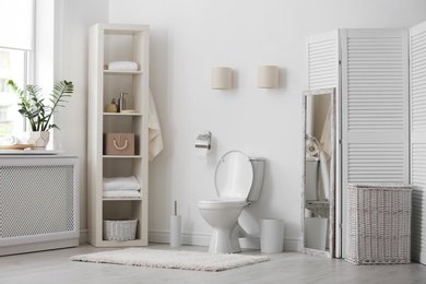 Toilet bowl in modern bathroom interior