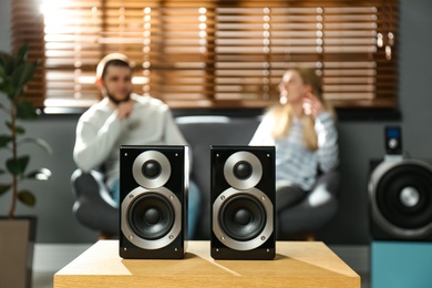 People enjoying music with modern audio speaker system in living room