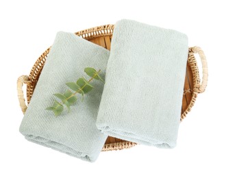 Basket with soft towels and eucalyptus branch isolated on white, top view