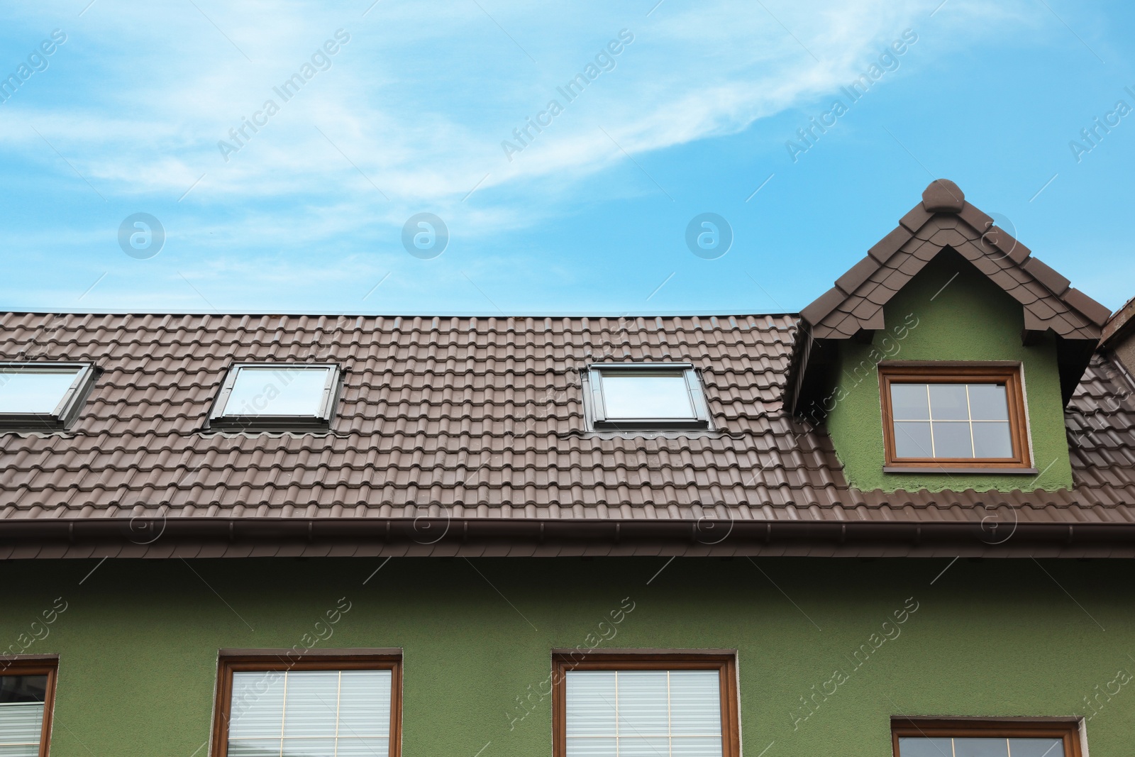 Photo of Beautiful house with color roof against blue sky, low angle view