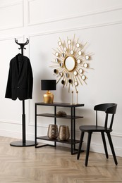 Hallway interior with console table near white wall