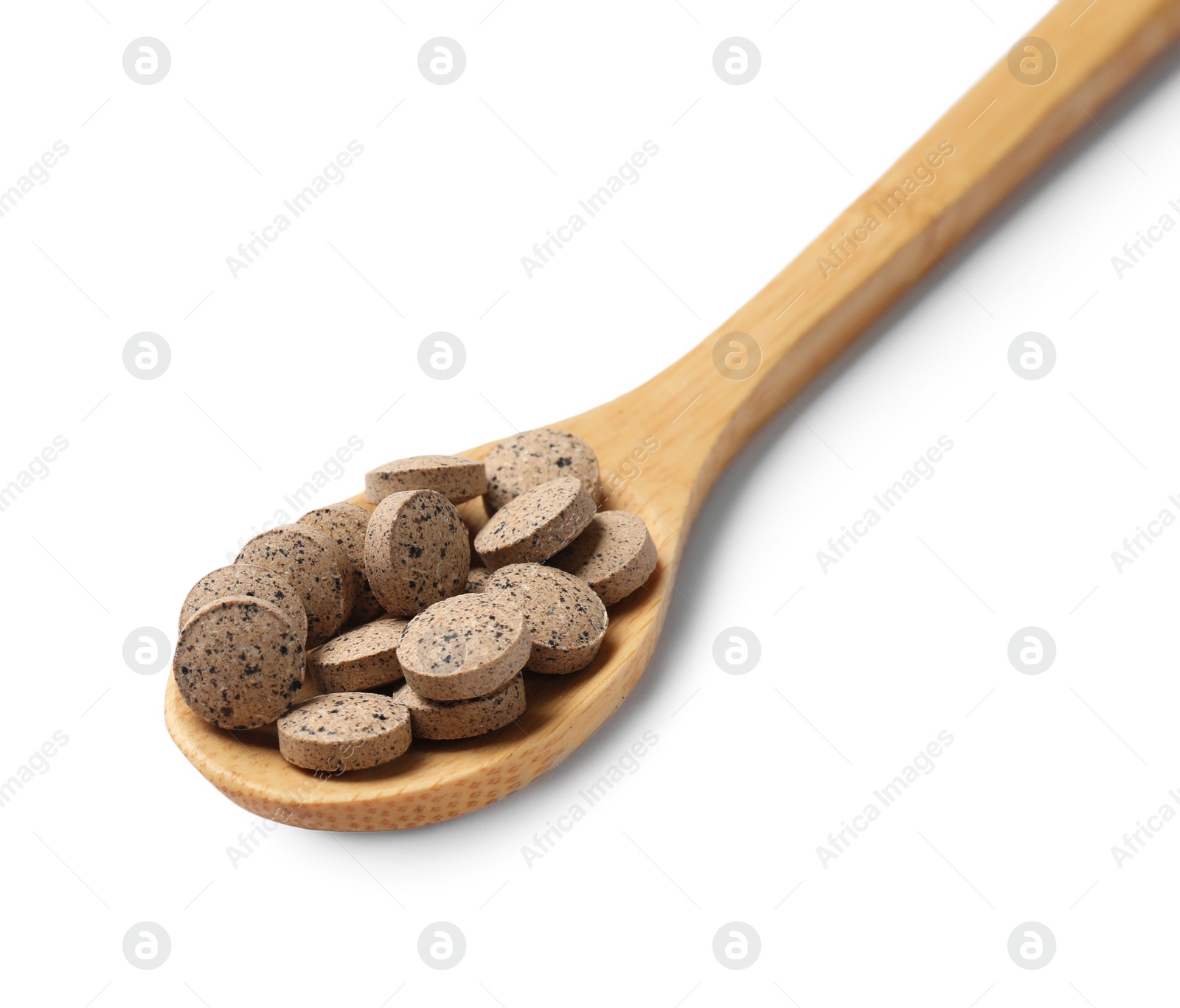 Photo of Vitamin pills in wooden spoon isolated on white